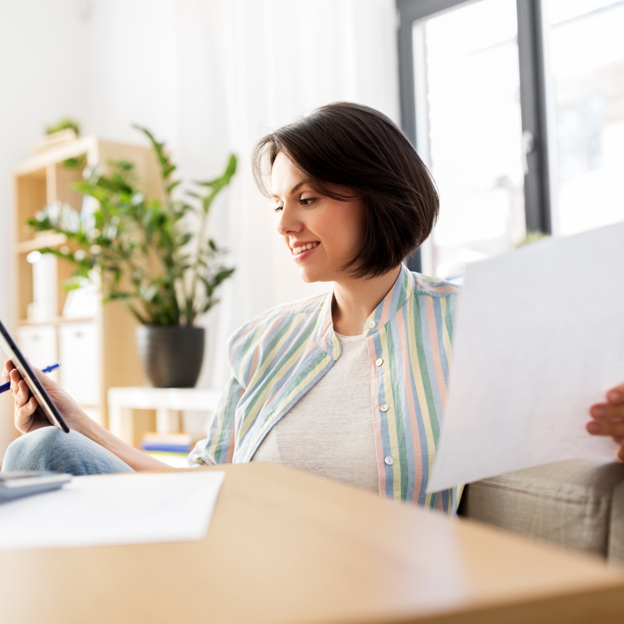 Woman working at home checking her freelance taxes